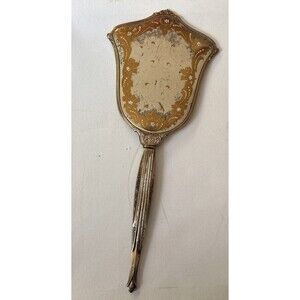 Vintage or antique gold-tone handheld vanity mirror.